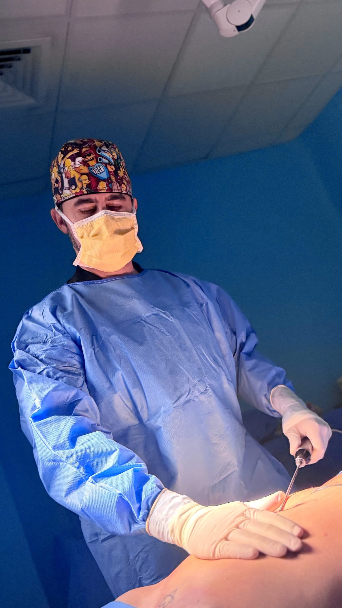 Plastic surgeon performing liposuction in the operating room