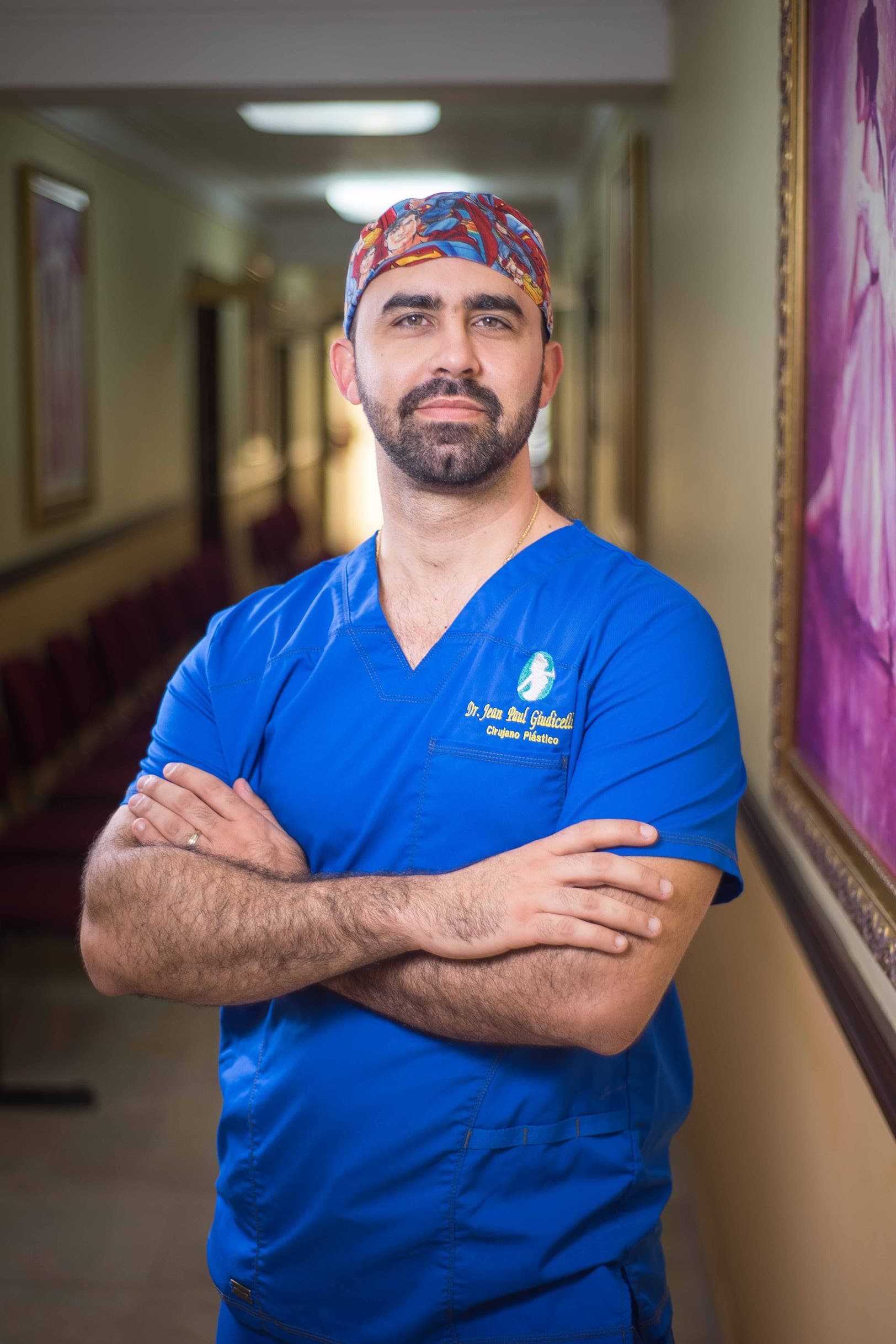 Dr. Jean Paul Giudicelli Saba in blue scrubs in a clinic hallway