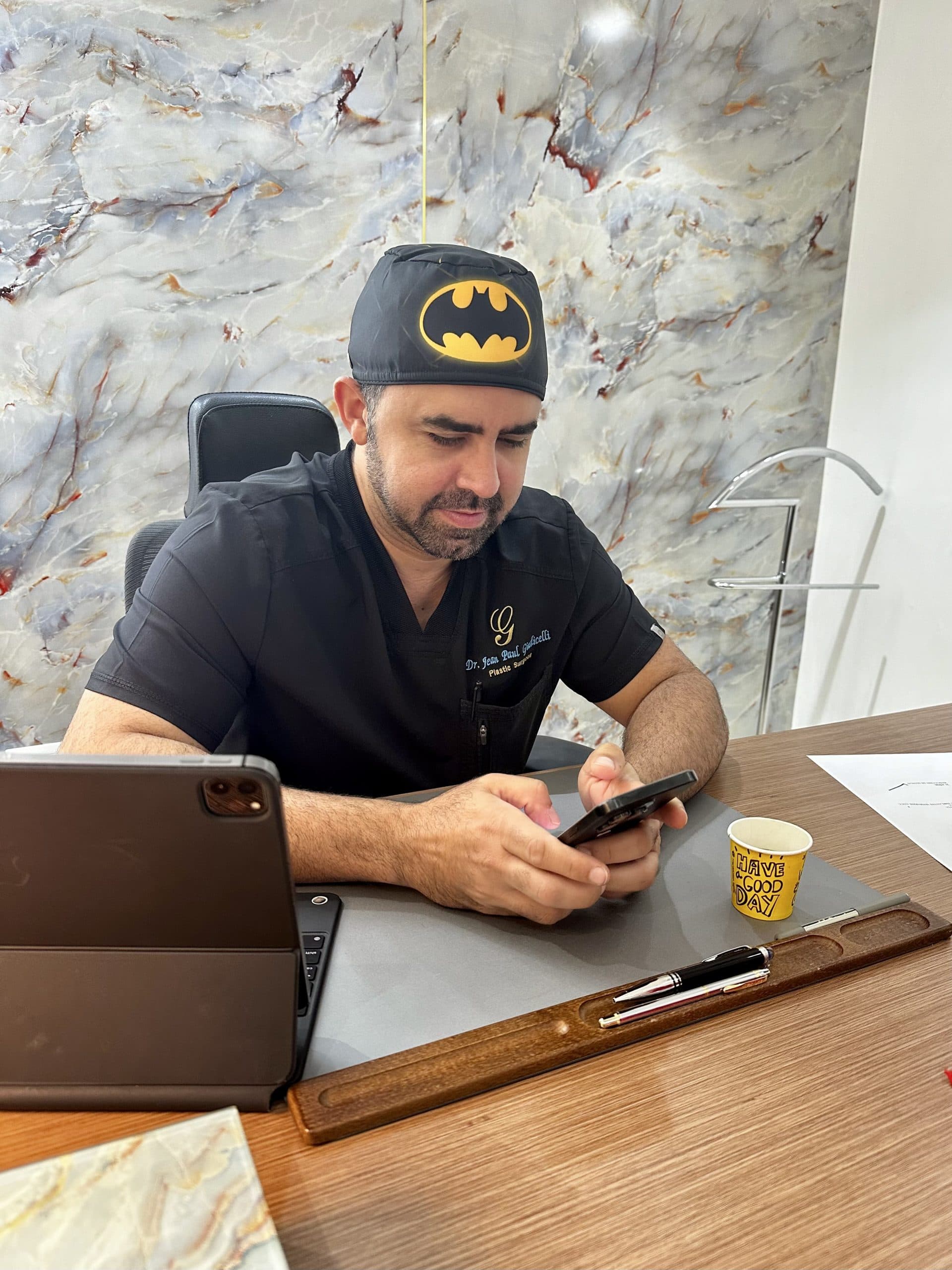 Dr. Jean Paul Giudicelli Saba working at his desk